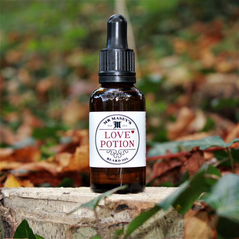 Mr Masey's Love Potion Beard Oil bottle in autumnal woodland setting