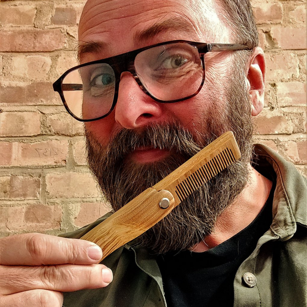 Mr Masey using Sandalwood folding beard comb