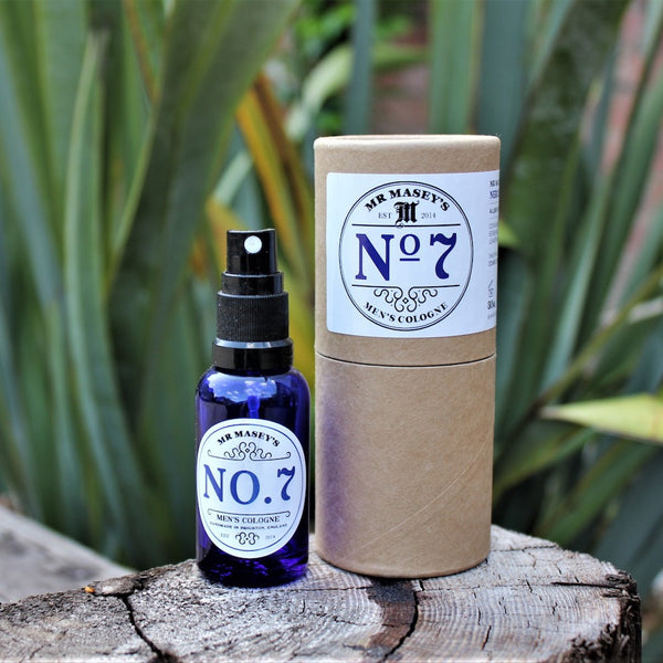 Mr Masey's No.7 Vegan Cologne Bottle and box on a tree stump