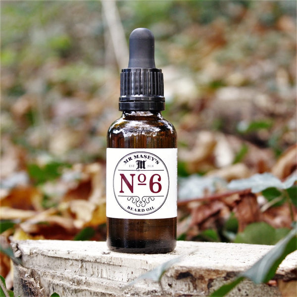 Mr Masey's No.6 Beard Oil bottle in autumnal woodland setting